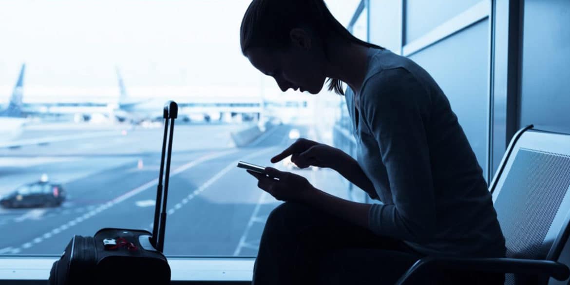 Woman sitting while browsing at the airport