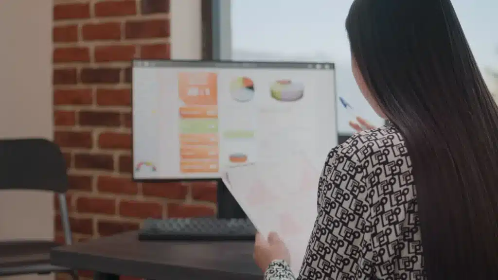 person analyzing data charts files in a computer